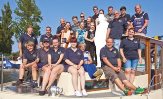 Alle Mitarbeiter des Charterteams auf einem Hausboot. 